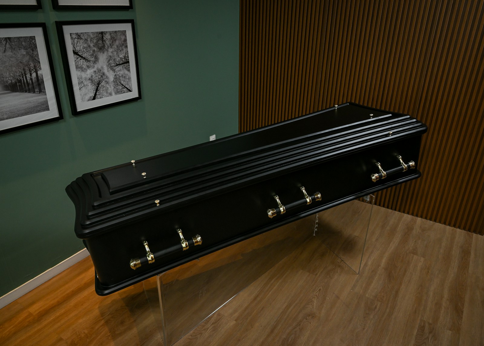 A black bench sitting on top of a hard wood floor